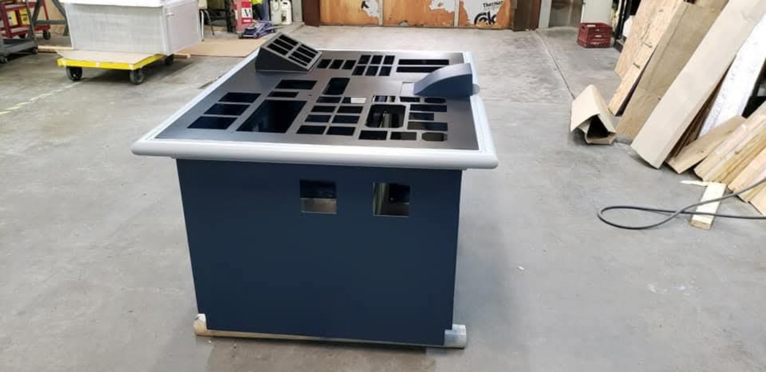 Custom metal equipment console with precise openings